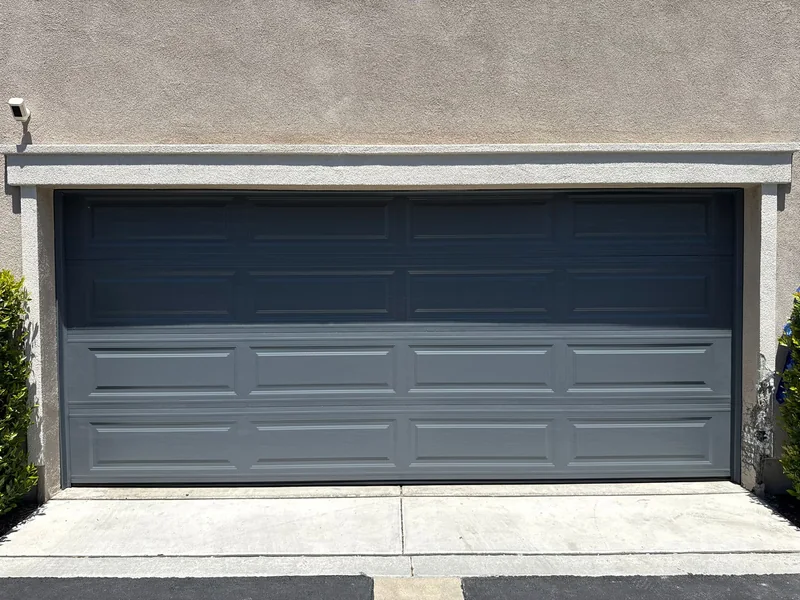Dark gray sectional garage door viewed from the driveway.