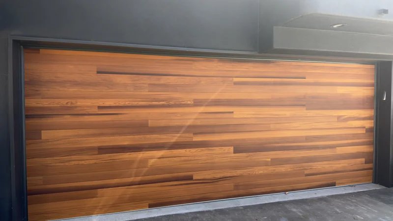 Garage door with a horizontal wood-tone finish.