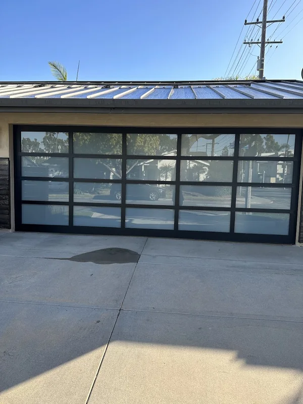 Black-framed garage door with a grid of glass panels.