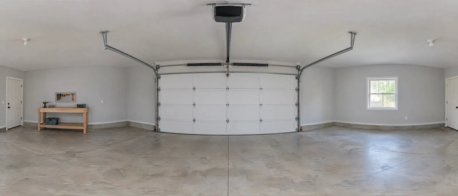 Design illustration of a garage interior: a white sectional door with its hardware and an opener on the ceiling.